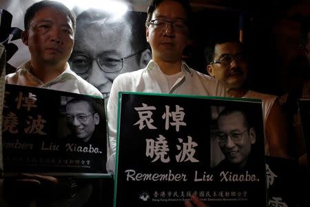 Pro-democracy activists mourn the death of Chinese Nobel Peace laureate Liu Xiaobo, outside China's Liaison Office in Hong Kong, China July 13, 2017. REUTERS/Bobby Yip