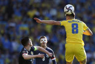 Ukraine's Ruslan Malinovskyi, right, duels for the ball with Scotland's Andrew Robertson, left, during the World Cup 2022 qualifying play-off soccer match between Scotland and Ukraine at Hampden Park stadium in Glasgow, Scotland, Wednesday, June 1, 2022. (AP Photo/Scott Heppell)