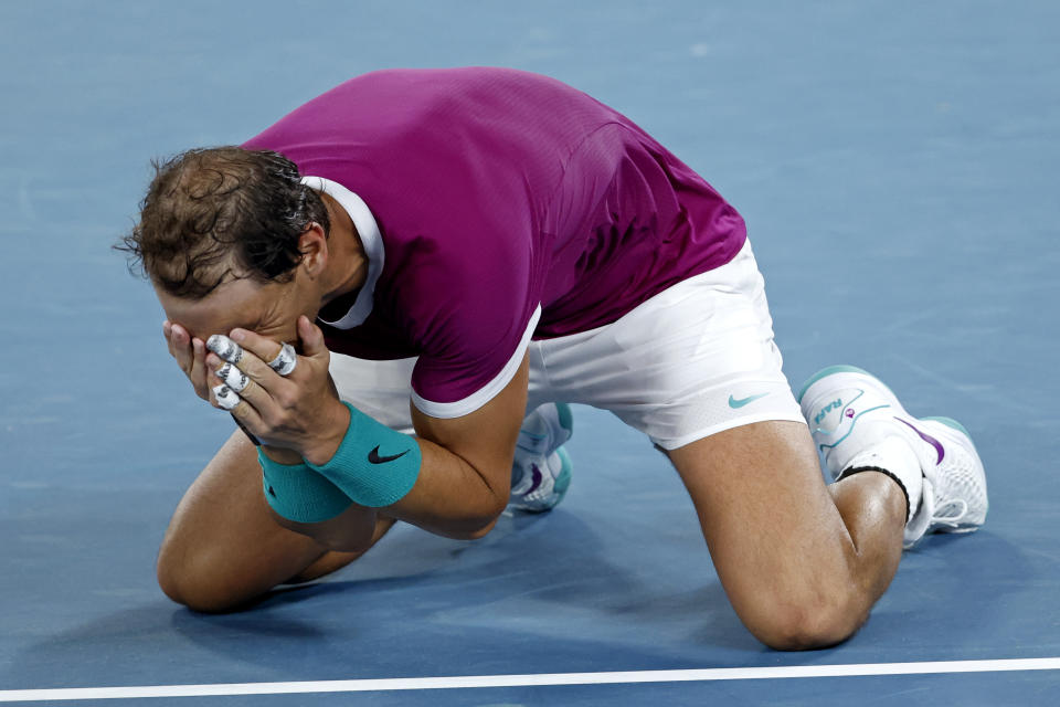 Rafael Nadal of Spain celebrates his win over Daniil Medvedev of Russia in the men's singles final at the Australian Open tennis championships in Melbourne, Australia, early Monday, Jan. 31, 2022. (AP Photo/Hamish Blair)