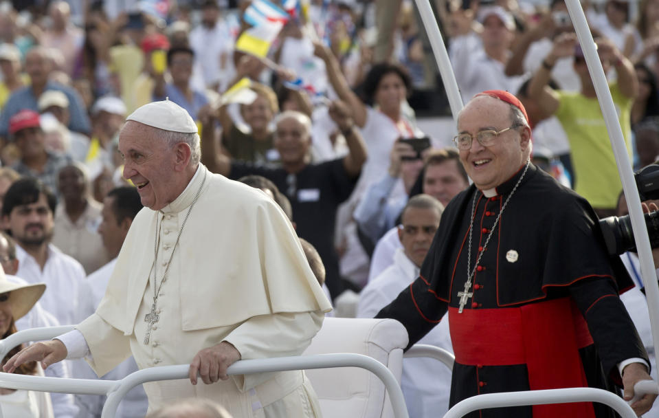 FILE - In this Sept. 20, 2015 file photo, Cuba's Cardinal Jaime Ortega, right, accompanies Pope Francis in the popemobile as they arrive for Mass at Revolution Plaza in Havana. Cuba's Roman Catholic Church said Friday, July 26, 2019, the former archbishop of Havana who helped organize the first papal visit to communist Cuba has died. Ortega was 83. (Ismael Francisco/Cubadebate Via AP File)