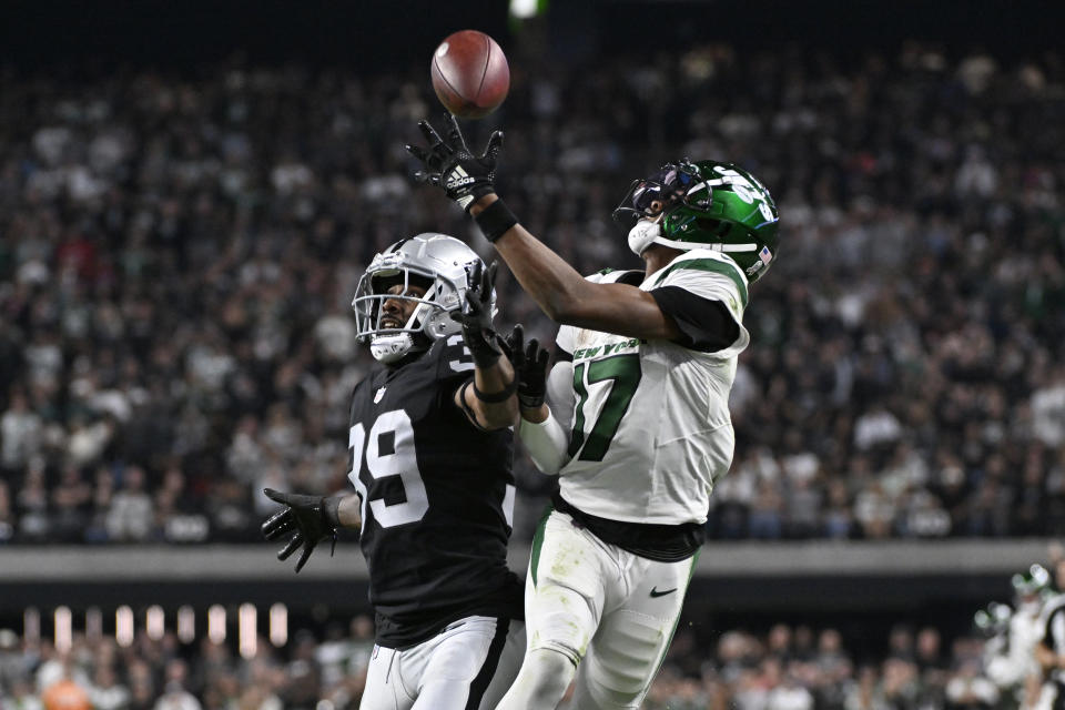 Las Vegas Raiders cornerback Nate Hobbs, left, breaks up a pass intended for New York Jets wide receiver Garrett Wilson (17) during the second half of an NFL football game Sunday, Nov. 12, 2023, in Las Vegas. (AP Photo/David Becker)