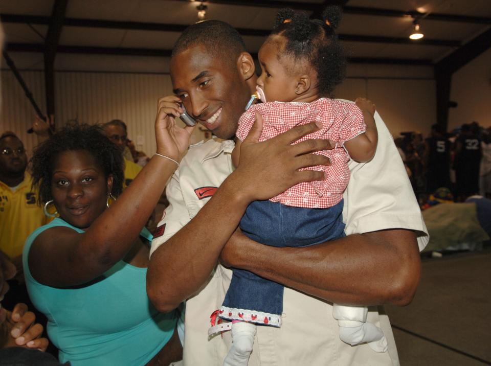 The star is seen here speaking with evacuees displaced by Hurricane Katrina during Kenny Smith's Hurricane Katrina relief effort and the NBA Players Charity Game event on Sept. 11, 2005, at Prince's Gym in Houston. The gym, at the time, was being used as a shelter for evacuees.