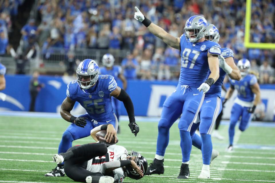 Detroit Lions defensive end Aidan Hutchinson (97) celebrates after linebacker Derrick Barnes (55) sacked Atlanta Falcons quarterback Desmond Ridder (9) during first-half action at Ford Field in Detroit on Sunday, Sept. 24, 2023.