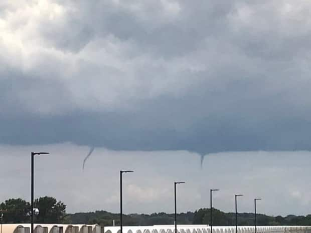 Two funnel clouds were spotted by someone living near Leamington, Ont., just before 1:30 p.m. ET Tuesday. (@RC87245549/Twitter - image credit)