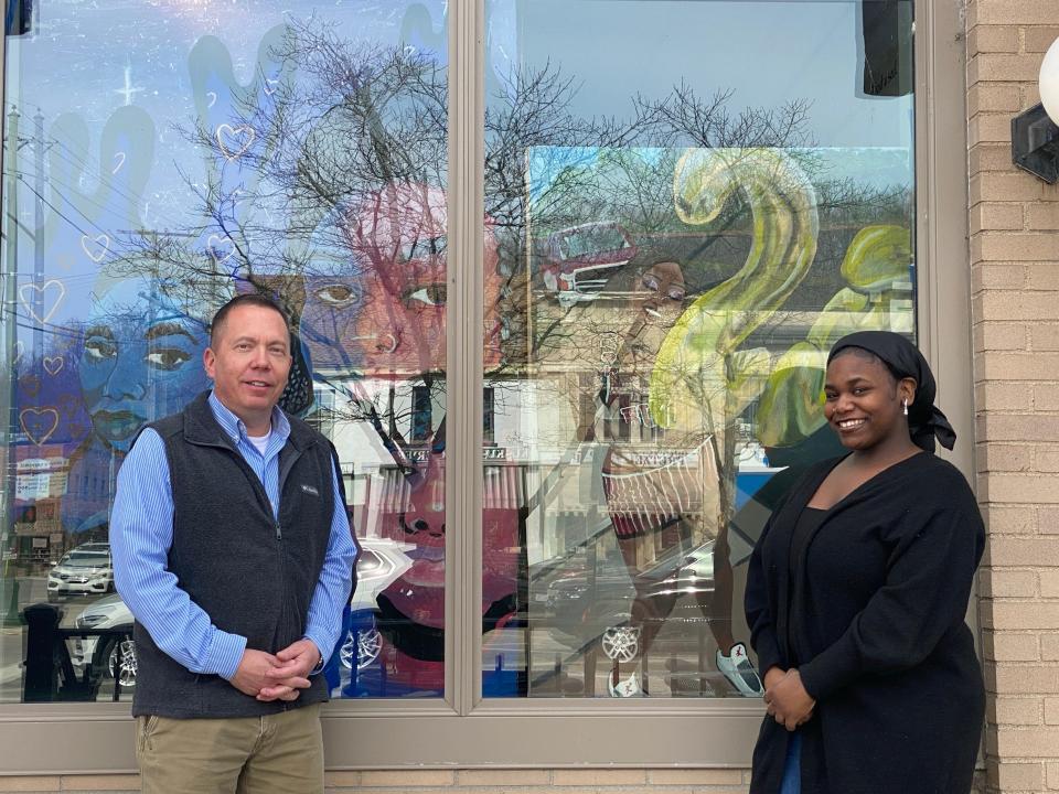 Granville Village Manager Herb Koehler and Denison University junior Renai Heath in front of her artwork now displayed at Granville Village Hall.