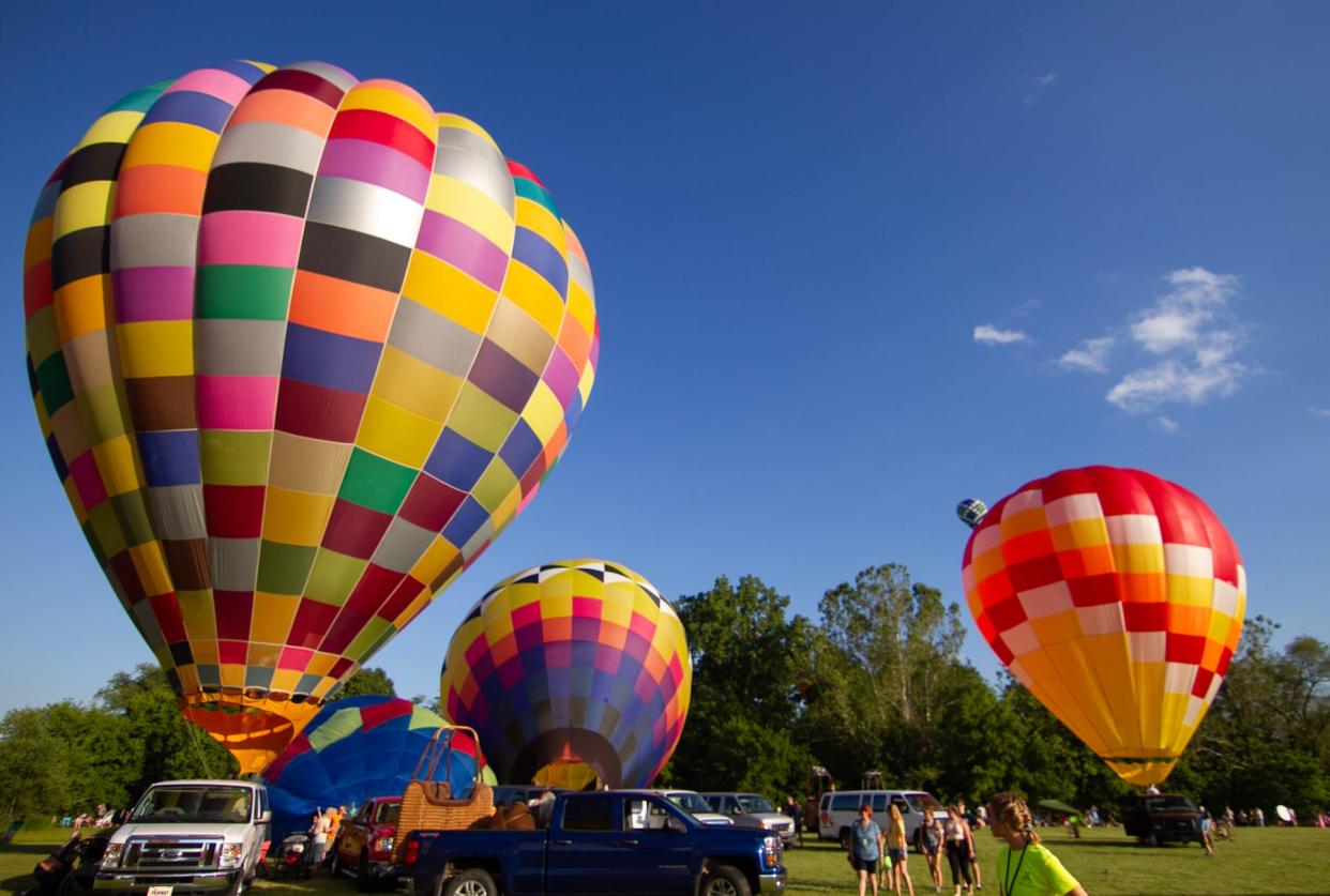 Joseph’s Coat, at left, Superfluous and Red Headed are filled with hot air as they ready to launch Saturday, June 29, 2019.