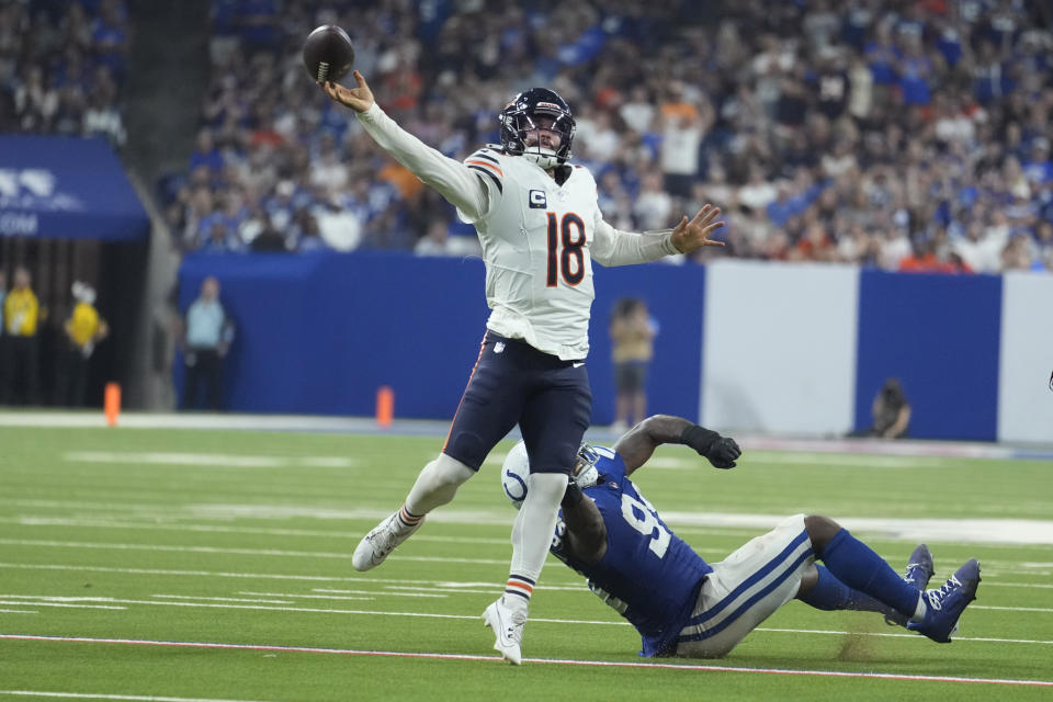 Chicago Bears quarterback Caleb Williams (18) is pressured by Indianapolis Colts defensive end Tyquan Lewis (94) during the second half of an NFL football game Sunday, Sept. 22, 2024, in Indianapolis. (AP Photo/Michael Conroy)