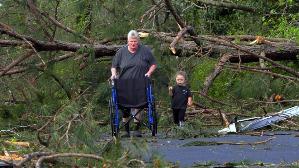 Angel Carpenter and her granddaughter Chelsey Monroe walk the grounds at the West Point Motel. Angel’s brother James Sheppard was staying at the motel when the tornado struck Sunday morning. 03/27/2023