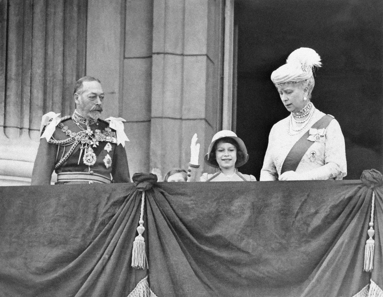 King George V, Princess Elizabeth waving to crowd, and Her Majesty Queen Mary on the balcony of Buckingham Palace in London on May 6, 1935 after attending the Jubilee service at St. Paul's Cathedral. 