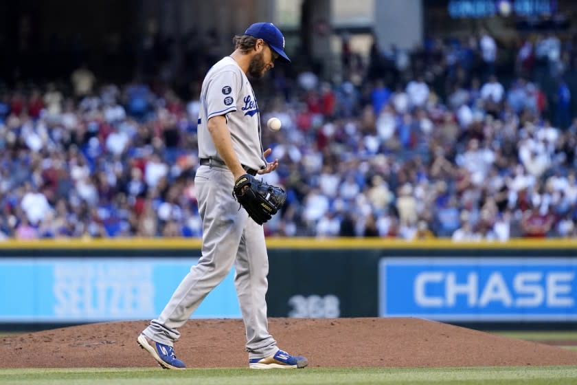 The Dodgers' Clayton Kershaw flips a new baseball after giving up a homer to Arizona's Carson Kelly on Sept. 25, 2021.