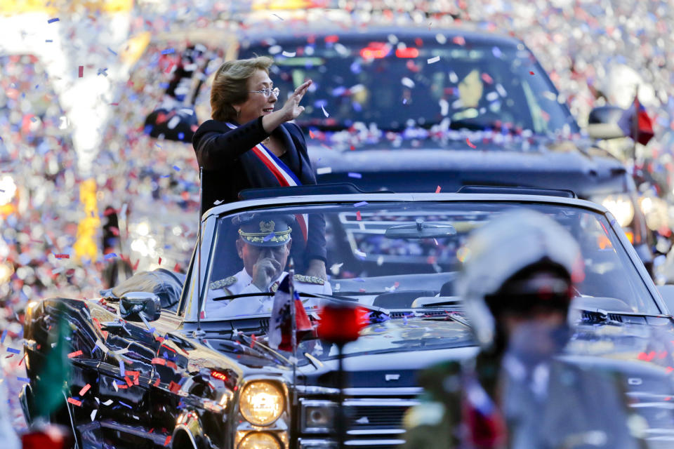 Confetti is thrown in the air as Chile's new President Michelle Bachelet waves from a car heading to La Moneda presidential palace in Santiago, Chile, Tuesday, March 11, 2014. Bachelet, who led Chile from 2006-2010, was sworn-in as president on Tuesday. (AP Photo/Victor R. Caivano)