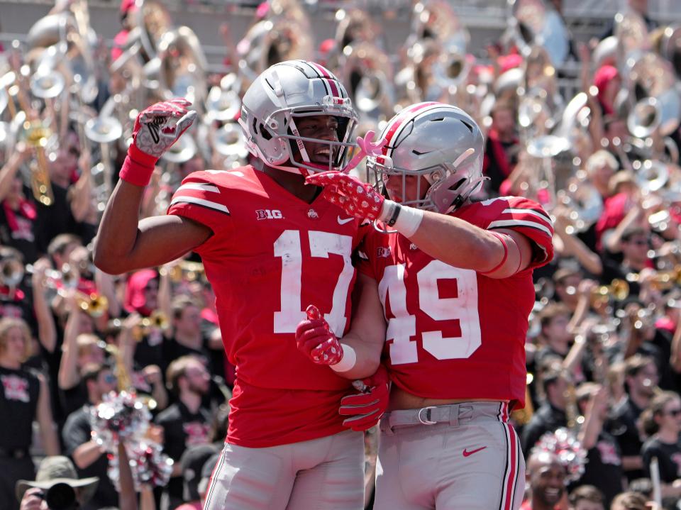 April 15, 2023; Columbus, Ohio, USA;  Wide receiver Carnell Tate (17) celebrates with tight end Patrick Gurd (49) after scoring a touchdown during the fourth quarter of the Ohio State spring football game Saturday at Ohio Stadium.Mandatory Credit: Barbara J. Perenic/Columbus Dispatch