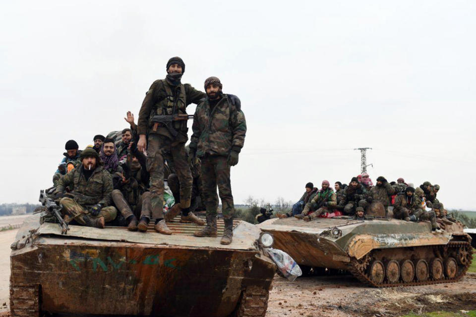 In this photo released Wednesday, Feb. 12, 2020, by the Syrian official news agency SANA, Syrian government soldiers on their armored vehicles patrol the highway that links the capital Damascus with the northern city of Aleppo, Syria. The M5 highway, recaptured by President Bashar Assad’s forces this week, is arguably the most coveted prize in Syria’s civil war. The strategic highway is vital for Syria’s economy as well as for moving troops. (SANA via AP)