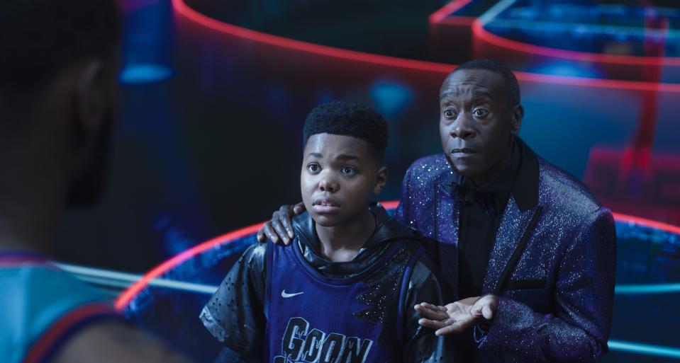 Al G. Rhythm (Don Cheadle, right) has control over LeBron James' son Dom (Cedric Joe) in "Space Jam: A New Legacy."