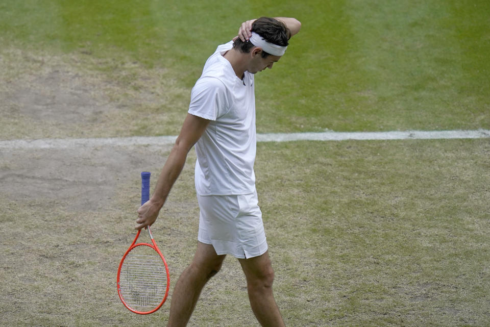 Taylor Fritz of the US reacts as he plays Spain's Rafael Nadal in a men's singles quarterfinal match on day ten of the Wimbledon tennis championships in London, Wednesday, July 6, 2022. (AP Photo/Gerald Herbert)