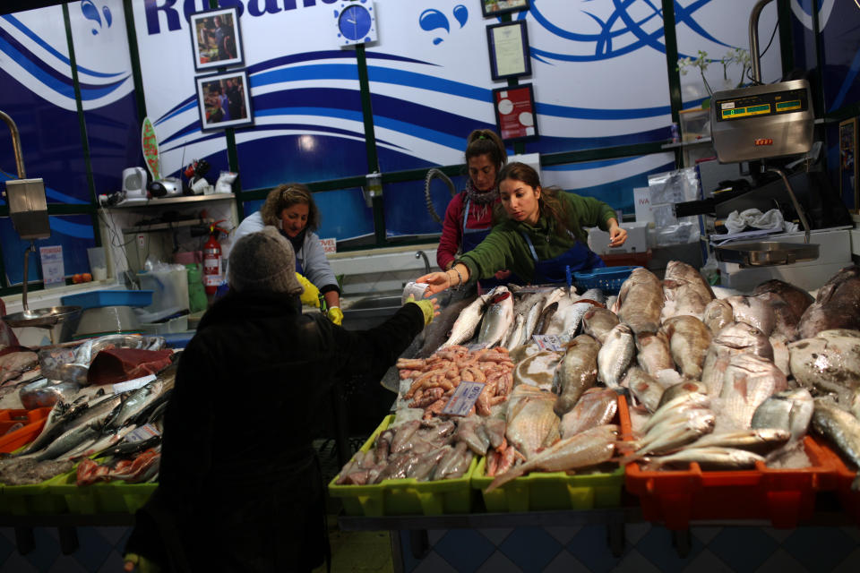 A woman receives a bill after paying for her fish at Lisbon's Ribeira food market, Tuesday, Feb. 11, 2014. Portugal, which uses the shared euro currency, was engulfed by the eurozone's debt crisis and needed an euro 78 billion (US$106.6 billion) rescue in 2011 to avoid bankruptcy as jittery investors deserted it. That money runs out in June, and the government is keen to re-establish access to markets before then. (AP Photo/Francisco Seco)