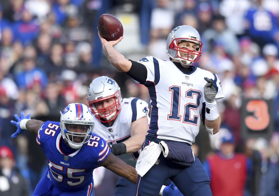 New England Patriots quarterback Tom Brady (12) throws a pass as Buffalo Bills defensive end Jerry Hughes (55) rushes by the block of offensive tackle Nate Solder (77) during the first half of an NFL football game, Sunday, Dec. 3, 2017, in Orchard Park, N.Y. (AP Photo/Rich Barnes)