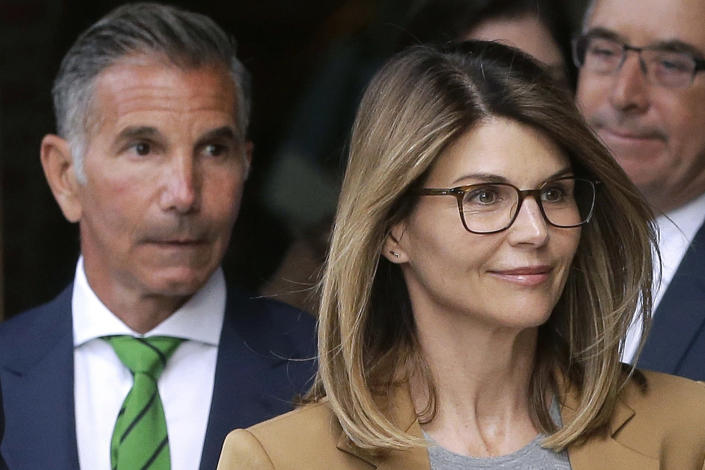 FILE - In this April 3, 2019 file photo, actress Lori Loughlin, front, and husband, clothing designer Mossimo Giannulli, left, depart federal court in Boston after facing charges in a nationwide college admissions bribery scandal. The famous couple pleaded guilty to charges in May 2020, and are scheduled to be sentenced on Friday, Aug. 21, 2020. (AP Photo/Steven Senne, File)