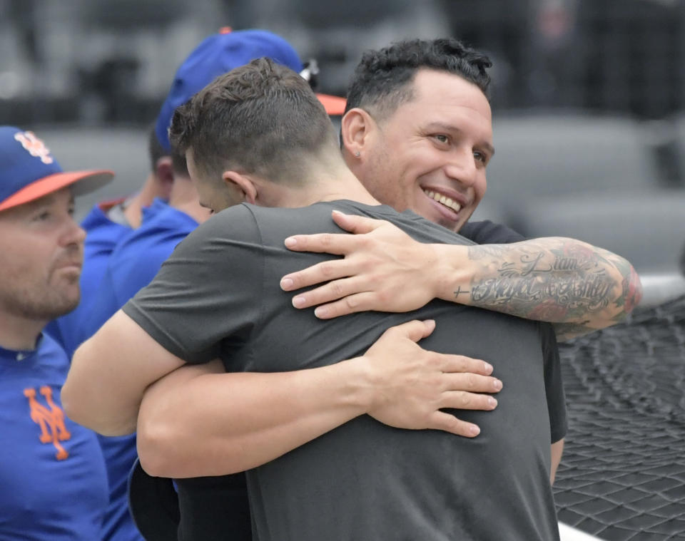 Philadelphia Phillies' Asdrubal Cabrera, right, hugs New York Mets' David Wright after Wright played in a simulated baseball game Saturday, Sept. 8, 2018, in New York. (AP Photo/Bill Kostroun)