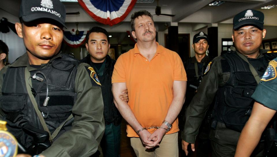 Suspected Russian arms dealer Viktor Bout, center, dubbed "The Merchat of Death" is escorted to a hearing at police headquarters by Thai authorities Friday, March, 7, 2008, in Bangkok, Thailand.  The United States is seeking extradition of Bout but he will remain in Thailand pending and investigation officials said Friday.