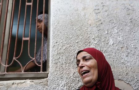 A relative of Issa al Qitri, a Palestinian man who was killed by Israeli troops, mourns during his funeral at al-Amari camp near the West Bank city of Ramallah September 10, 2014. REUTERS/Mohamad Torokman