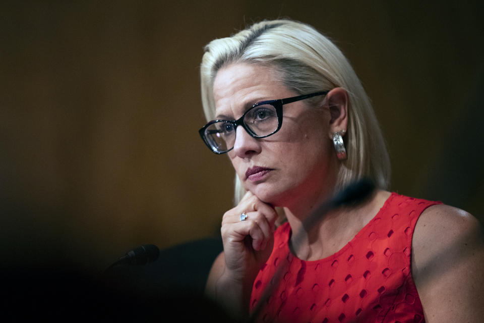 FILE - In this July 16, 2019, file photo, Senate Security and Governmental Affairs Committee member Sen. Kyrsten Sinema, D-Ariz., listens to witnesses during a hearing on 2020 census on Capitol Hill in Washington. More than her shock of purple hair or unpredictable votes Sinema is perhaps best known for doing the unthinkable in Washington: spending time on the Republican side of the aisle. Her years in Congress have been a whirlwind of political style and perplexing substance, an anti-war liberal-turned-deal-making centrist who now finds herself at the highest levels of power. (AP Photo/Manuel Balce Ceneta)