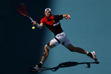 Mar 26, 2019; Miami Gardens, FL, USA; John Isner of the United States hits a forehand against Kyle Edmund of Great Britain (not pictured) in the fourth round of the Miami Open at Miami Open Tennis Complex. Mandatory Credit: Geoff Burke-USA TODAY Sports