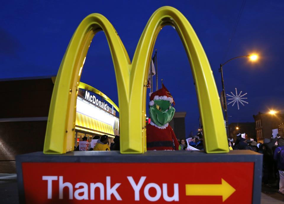 A protestor dressed up as the fictional character the "Grinch" demonstrates outside a McDonald's restaurant in Chicago, Illinois, December 5, 2013. Fast food workers are calling for increased wages. (REUTERS/Jim Young)