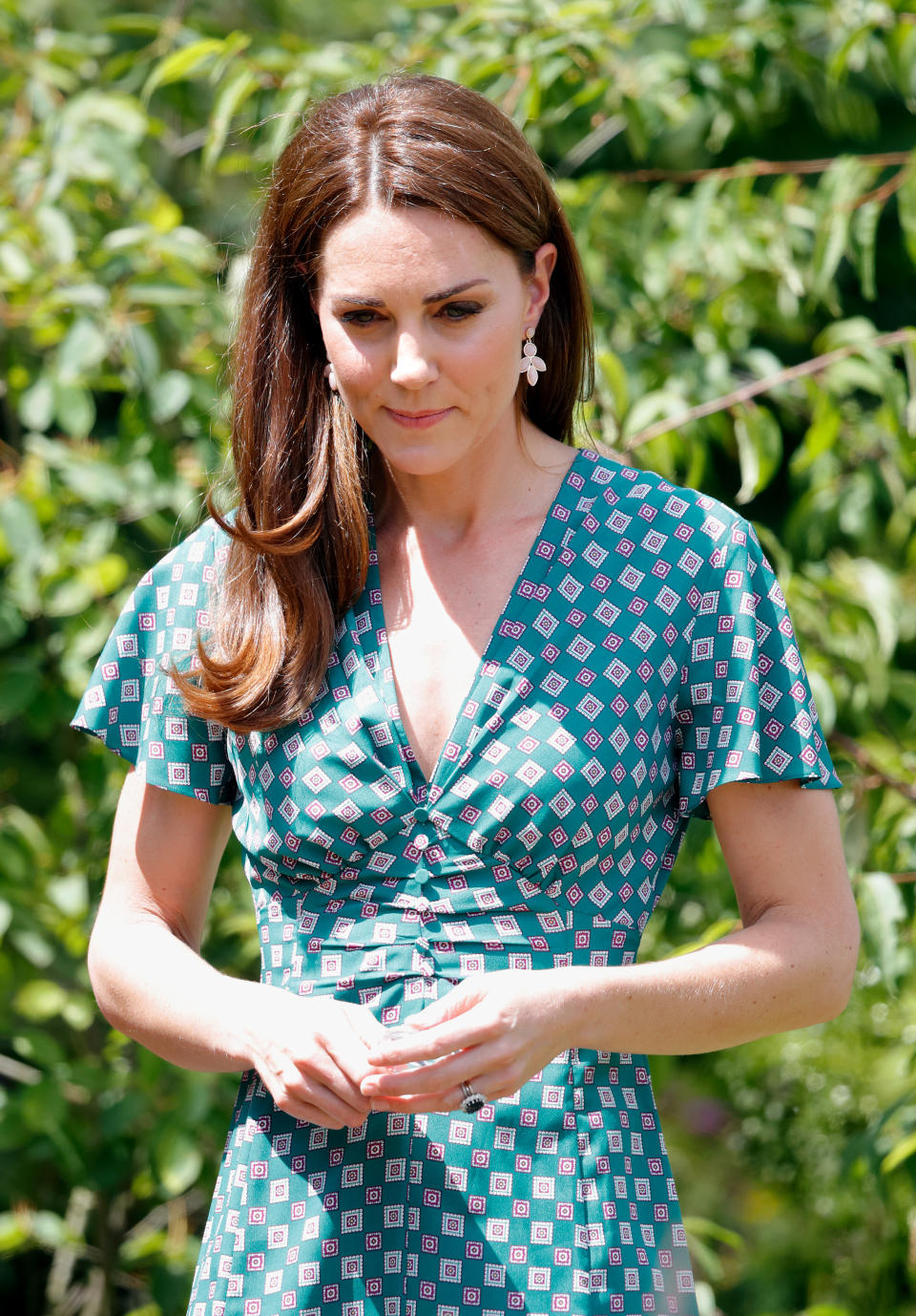 The Duchess of Cambridge paired her £8 Accessorize earrings with a ruffled floral printed dress from &OtherStories [Photo: Getty Images]