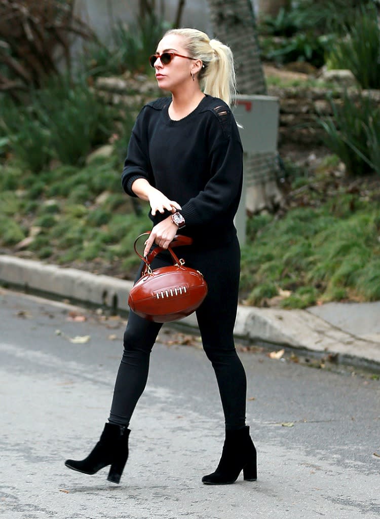 Gaga heads to the home of Bradley Cooper with a pigskin purse on her arm. (Photo: AKM-GSI)