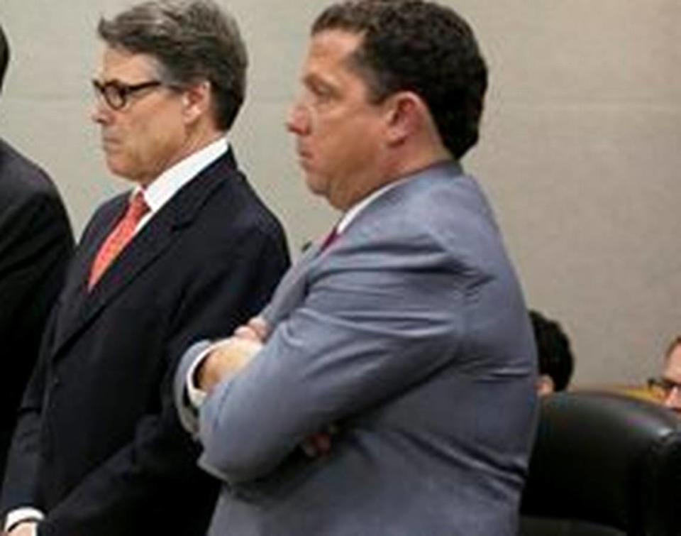 Texas Gov. Rick Perry and lawyer Tony Buzbee appeared for a hearing on felony abuse of power charges Thursday, Nov. 6, 2014, in Austin, Texas.