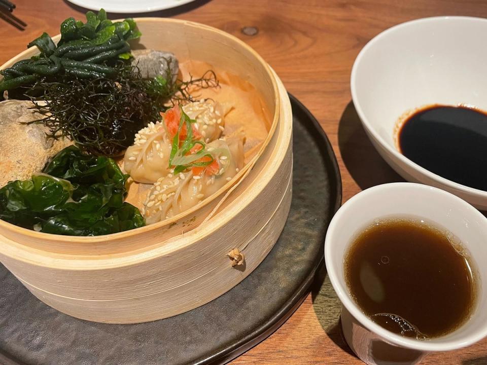 Crab dumplings are served with steamed seaweed for the aroma (Kate Ng)