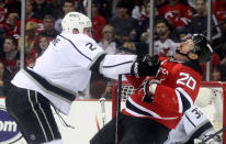 NEWARK, NJ - JUNE 02: Matt Greene #2 of the Los Angeles Kings hits Ryan Carter #20 of the New Jersey Devils during Game Two of the 2012 NHL Stanley Cup Final at the Prudential Center on June 2, 2012 in Newark, New Jersey. (Photo by Elsa/Getty Images)