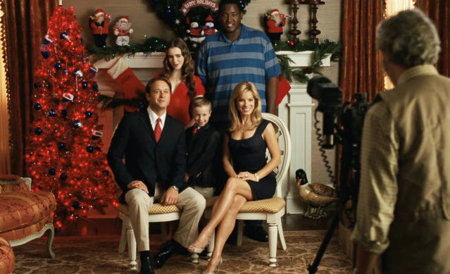 The Tuohy family and Michael next to a Christmas tree