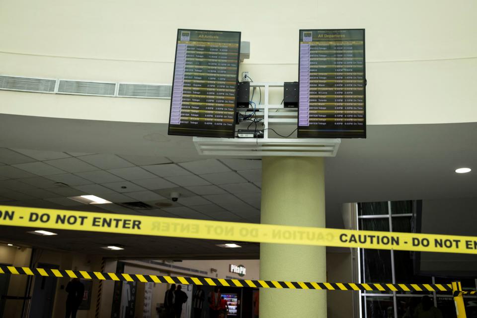 Info screens at the Piarco International Airport as several flights are canceled due to Hurricane Beryl, in Piarco, Trinidad and Tobago, Monday.
