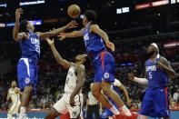 Mar 17, 2019; Los Angeles, CA, USA; Brooklyn Nets guard Treveon Graham (21) and LA Clippers guard Lou Williams (23) and guard Shai Gilgeous-Alexander (2) compete for a loose ball during the fourth quarter at Staples Center. Mandatory Credit: Jake Roth-USA TODAY Sports
