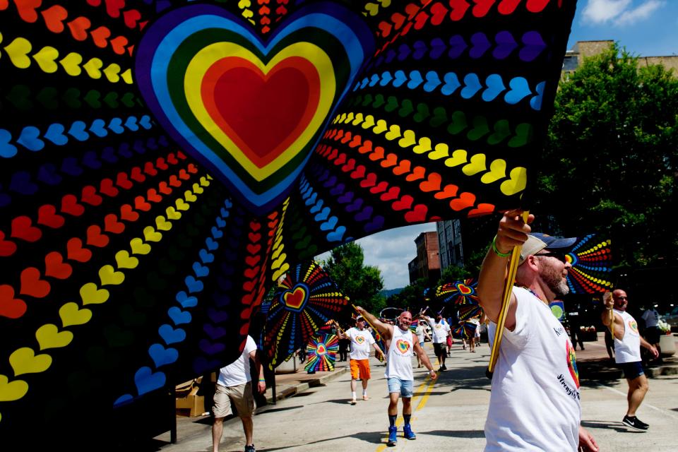 Paraders wave their flags during the annual Knoxville Pride Fest Parde in downtown Knoxville, Tennessee on Saturday, June 17, 2017.