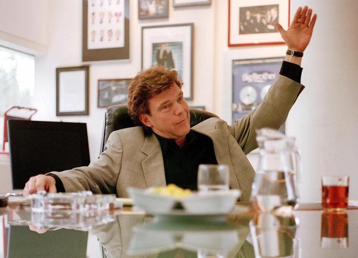 FILE- President of Dutch television production company Endemol, John de Mol, gestures while answering a question at his private office in Hilversum, Netherlands, Jan. 23, 2001. De Mol, the former producer of Dutch talent show "The Voice of Holland" apologized Thursday Jan. 20, 2022, after allegations of sexually inappropriate conduct linked to the ratings blockbuster were aired. Police and prosecutors called reports of the alleged abuse "disturbing" and urged victims to come forward with their experiences. (AP Photo/Serge Ligtenberg, File)