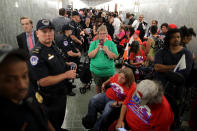 <p>Dozens of U.S. Capitol Police officers line the hallway and keep watch on people waiting to attend the Senate Finance Committee hearing about the proposed Graham-Cassidy Healthcare Bill in the Dirksen Senate Office Building on Capitol Hill September 25, 2017 in Washington, DC. Demonstrators plan to disrupt the hearing to protest the legislation, the next in a series of Republican proposals to replace the Affordable Care Act, also called Obamacare. (Photo: Chip Somodevilla/Getty Images) </p>