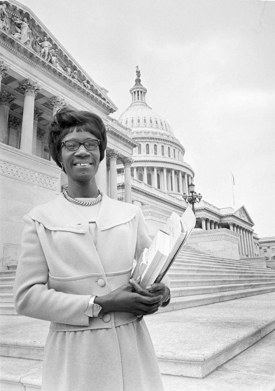 FILE - In this March 26, 1969, file photo, Rep. Shirley Chisholm, D-N.Y., poses on the steps of the Capitol in Washington with material she plans to use in a speech before the House of Representatives. Fifty years have passed since the Brooklyn, N.Y. native made history on Nov. 5, 1968, as the first African-American woman elected to Congress. (AP Photo/Charles Gorry, File)