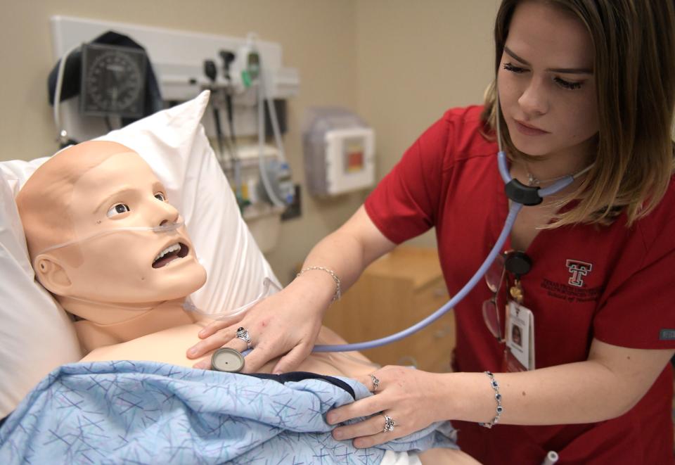 Chloe Douglas checks the dummy at the F. Marie Hall SimLife Center, Tuesday, Feb. 27, 2024, at Texas Tech University Health Sciences Center.