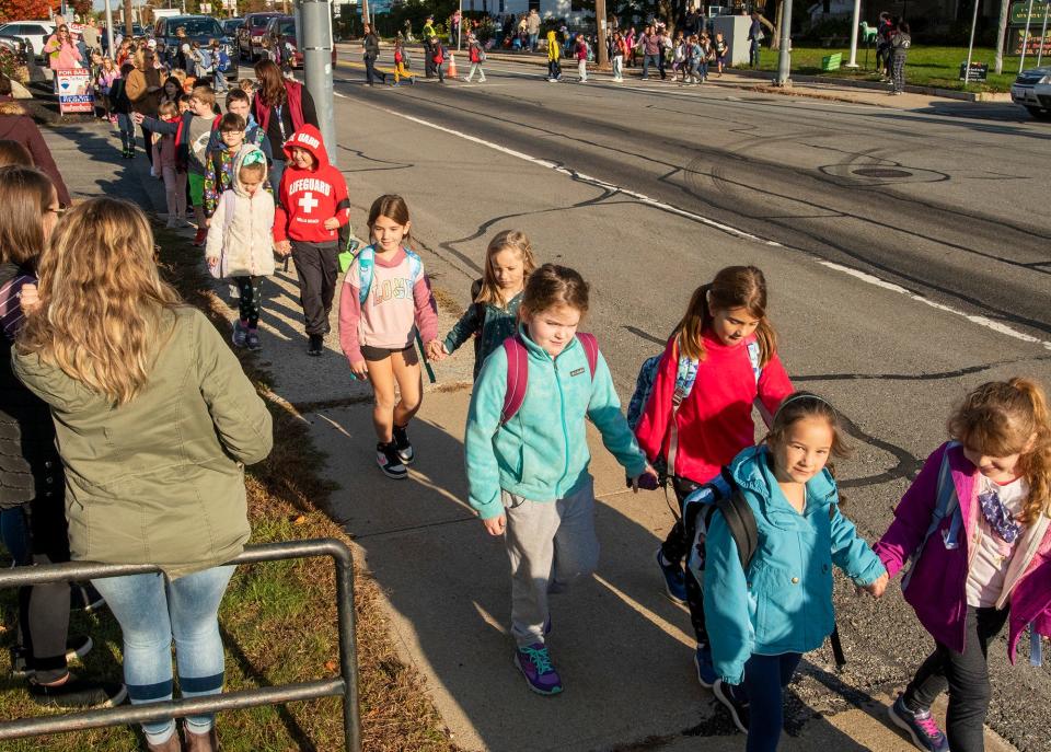 Students cross Main Street in Westminster during their half-mile walk Wednesday to Meetinghouse School and Westminster Elementary School on  Walk, Bike & Roll to School Day.