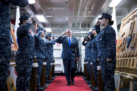 U.S. Vice President Mike Pence, salutes as he boards the USS Ronald Reagan aircraft carrier in Yokosuka, Kanagawa, Japan, on Wednesday, April 19, 2017. REUTERS/Tomohiro Ohsumi/Pool