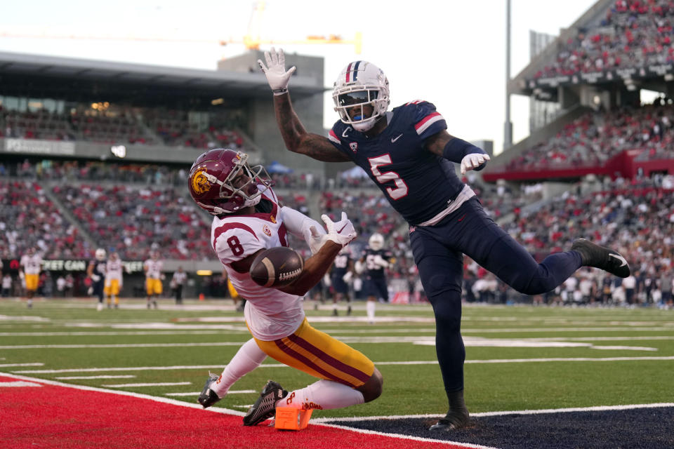 Oct 29, 2022; Tucson, Arizona, USA; Arizona Wildcats safety Christian Young (5) breaks up a pass intended for USC Trojans wide receiver CJ Williams (8) during the first half at Arizona Stadium. Mandatory Credit: Joe Camporeale-USA TODAY Sports