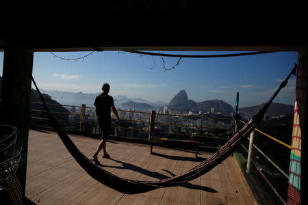 A man walks along a terrace at Pousada Favelinha (Little favela) hostel in Pereira da Silva favela, in Rio de Janeiro, Brazil, April 21, 2016. REUTERS/Pilar Olivares