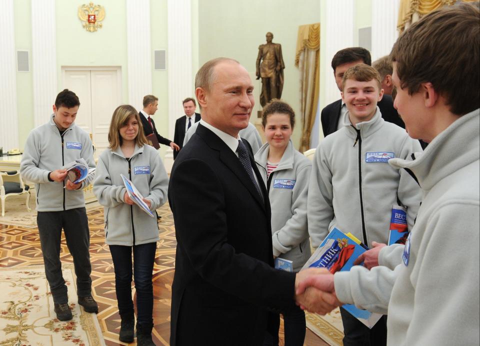 Russian President Vladimir Putin meets with young skiers, participants in the expedition to the North Pole, in the Kremlin in Moscow, Russia, Tuesday, April 22, 2014. (AP Photo/RIA-Novosti, Mikhail Klimentyev, Presidential Press Service)