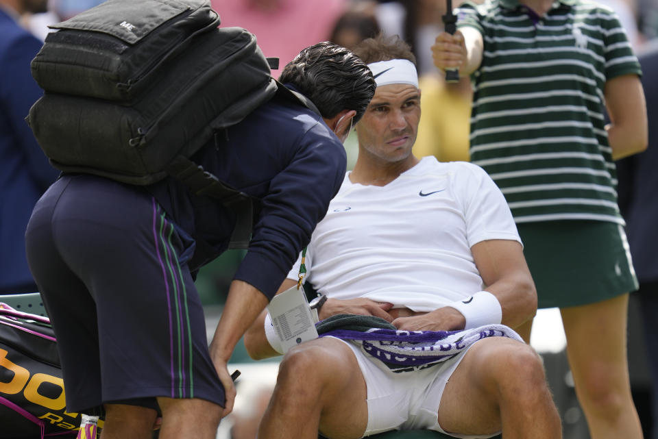 FILE - Spain's Rafael Nadal receives treatment just before a medical timeout as he plays Taylor Fritz of the US in a men's singles quarterfinal match on day ten of the Wimbledon tennis championships in London, Wednesday, July 6, 2022. (AP Photo/Kirsty Wigglesworth, File)