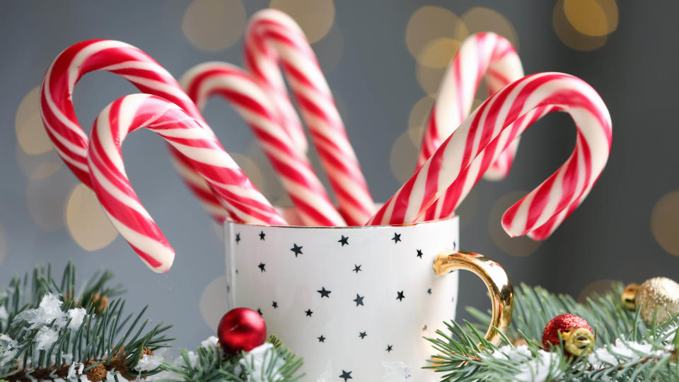 A cup filled with candy canes