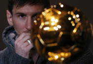 FIFA Men's Ballon d'Or of the Year 2012 nominee Lionel Messi of Argentina looks at the trophy during a news conference before the FIFA Ballon d'Or 2012 soccer awards ceremony at the Kongresshaus in Zurich January 7, 2013. REUTERS/Michael Buholzer (SWITZERLAND - Tags: SPORT SOCCER TPX IMAGES OF THE DAY)