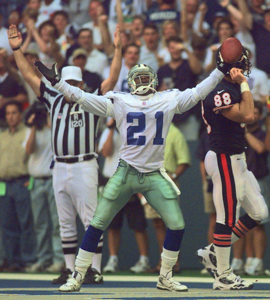 1997: Deion Sanders celebrates his 83-yard punt return touchdowns against the Chicago Bears.